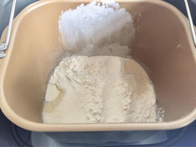 除开黄油之外的其他原料一次性按照液体到固体的顺序倒入面包机桶内
