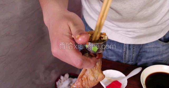 把腌好的鸡翅拿出，炒好的米饭放入鸡翅里(三分之二满，否则熟了会爆开)
满好的鸡翅用牙签封住