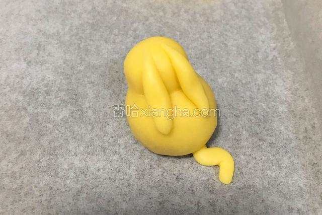 取少许小面团做出皮卡丘的耳朵和尾巴，粘到身体上。