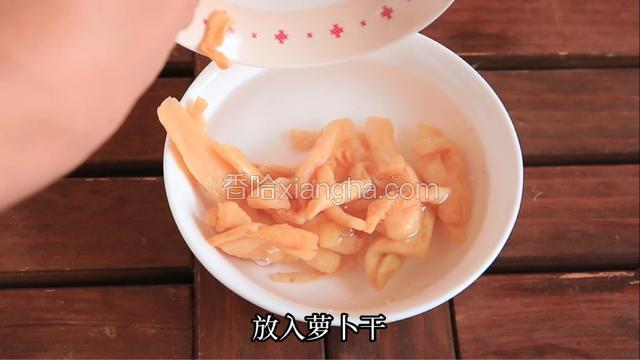 调一碗淡盐水，放入萝卜干浸泡半小时。