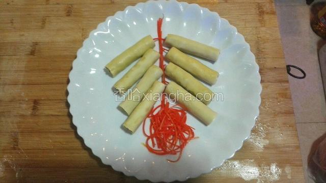 将爆竹对放摆入盘中，中间用胡萝卜丝摆一条线，下面用胡萝卜丝摆个燃放的状态