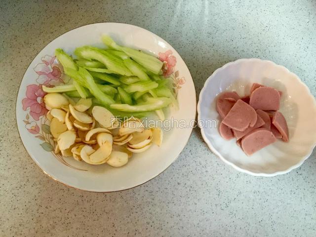 将熟火腿和西芹切片，把百合掰成小瓣洗净待用；