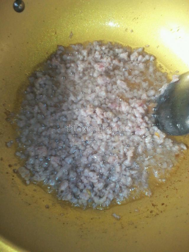 起锅烧油热放入猪肉粒，拿勺子划散变色，放入料酒煸炒