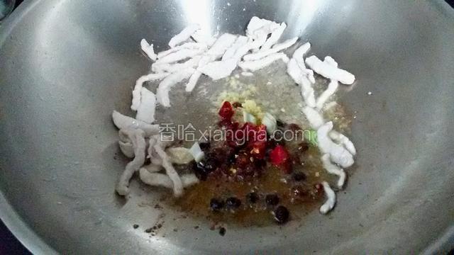 油热后放肉丝煸香，然后放入葱姜干辣椒炒一下，再放入豆豉煸炒。