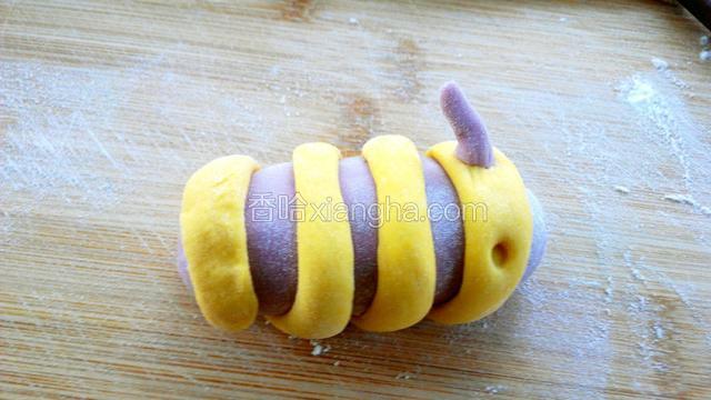
用筷子在接近头部的黄色面上压一个小坑，将触角放上去